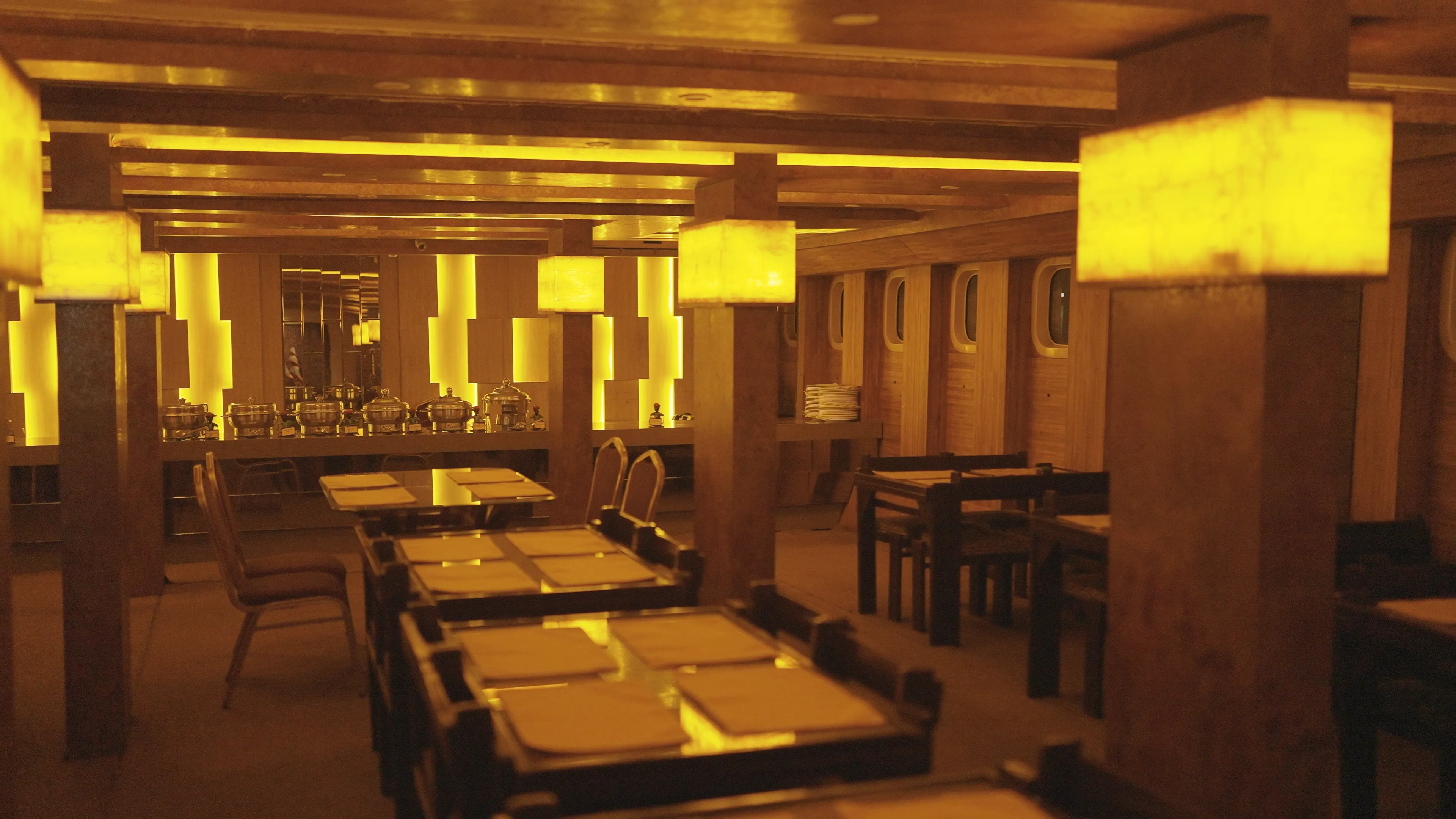 Warm golden interior of the Alfresco Grand dining hall set for dinner