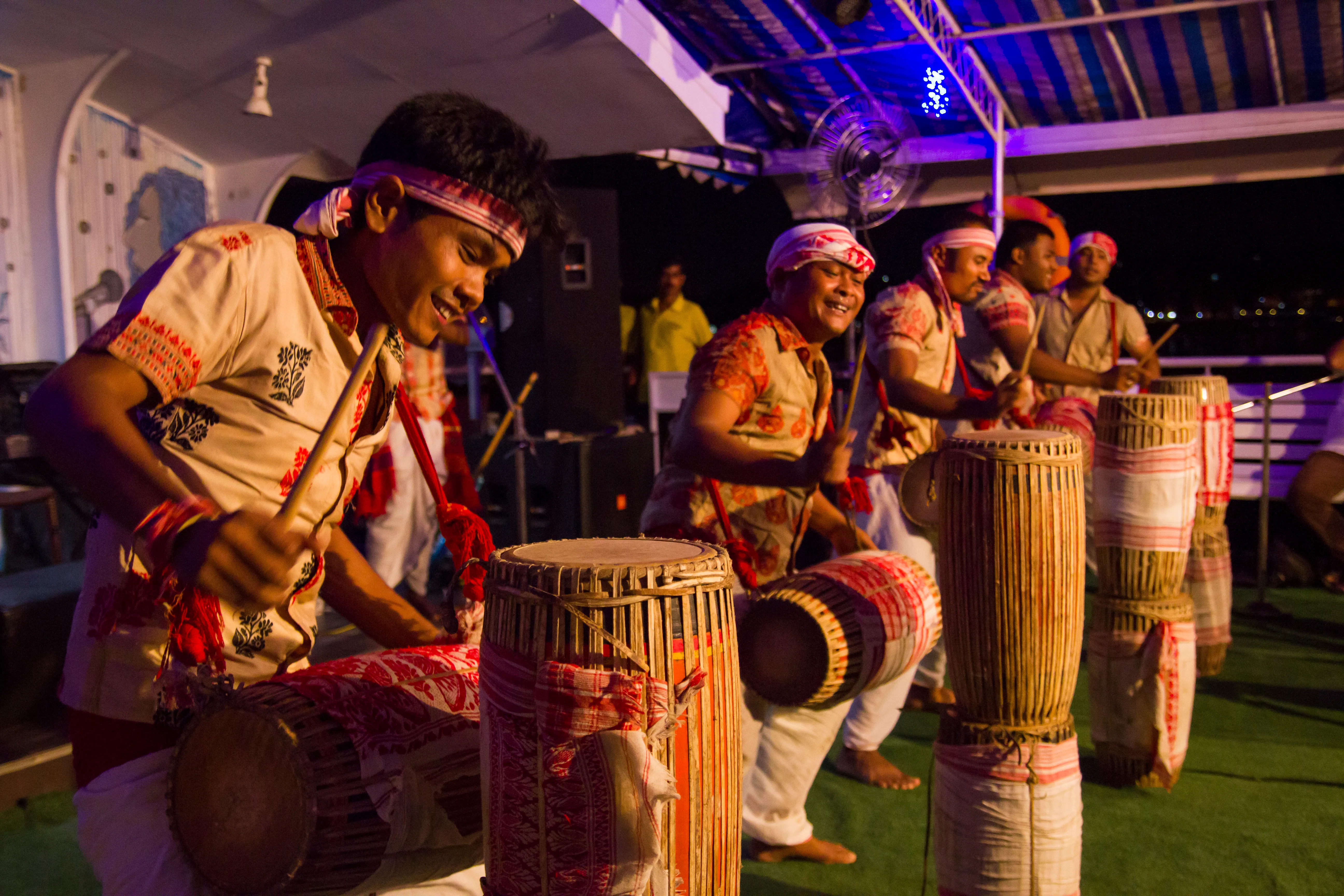 Dhol drummers in traditional dress performing on the dinner cruise deck