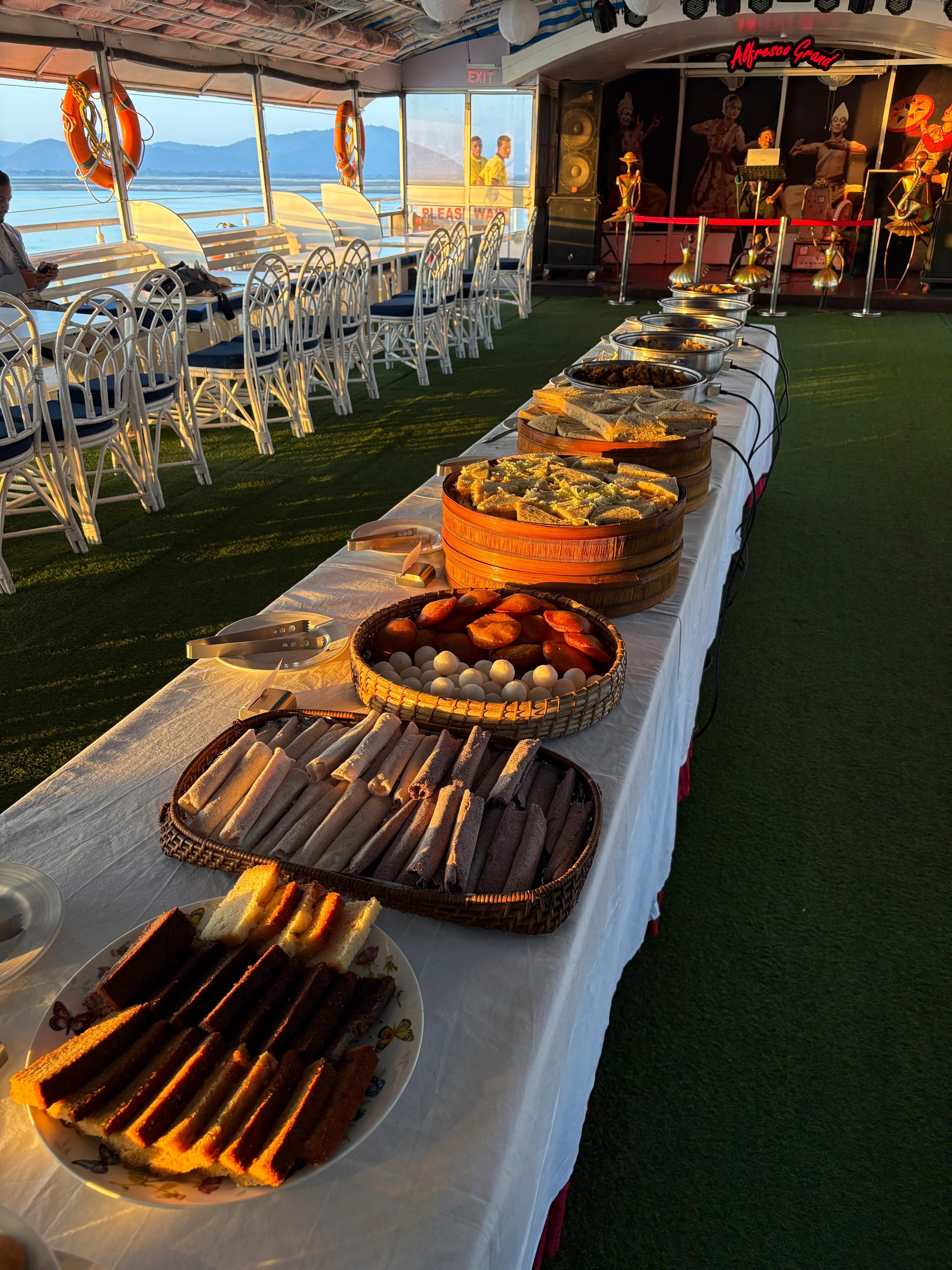 Snacks and tea served at golden hour on the Brahmaputra sunset cruise