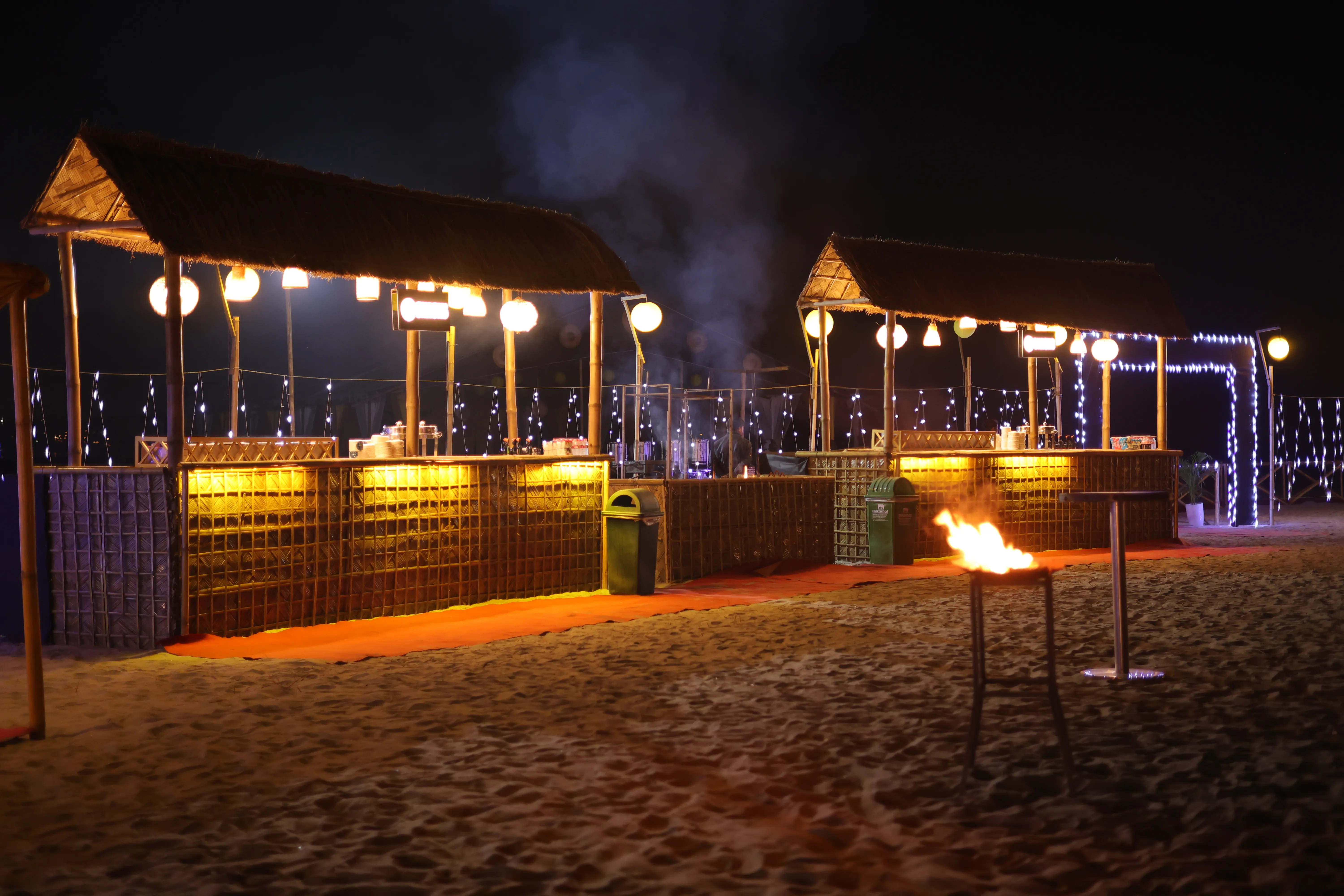 Live food stalls and bonfire at a night event on the river island