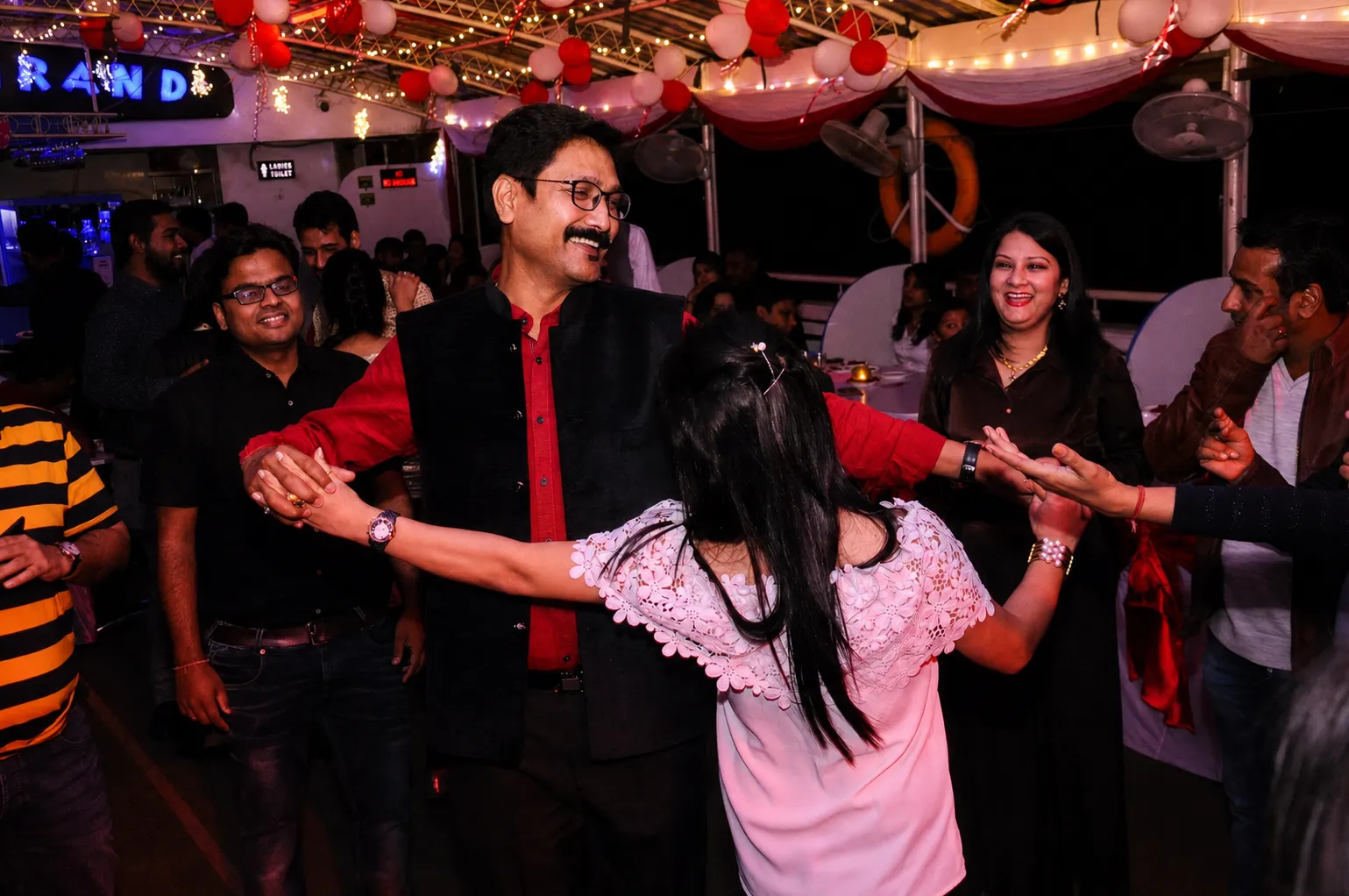 Guests dancing at a private charter party on the deck of Alfresco Grand