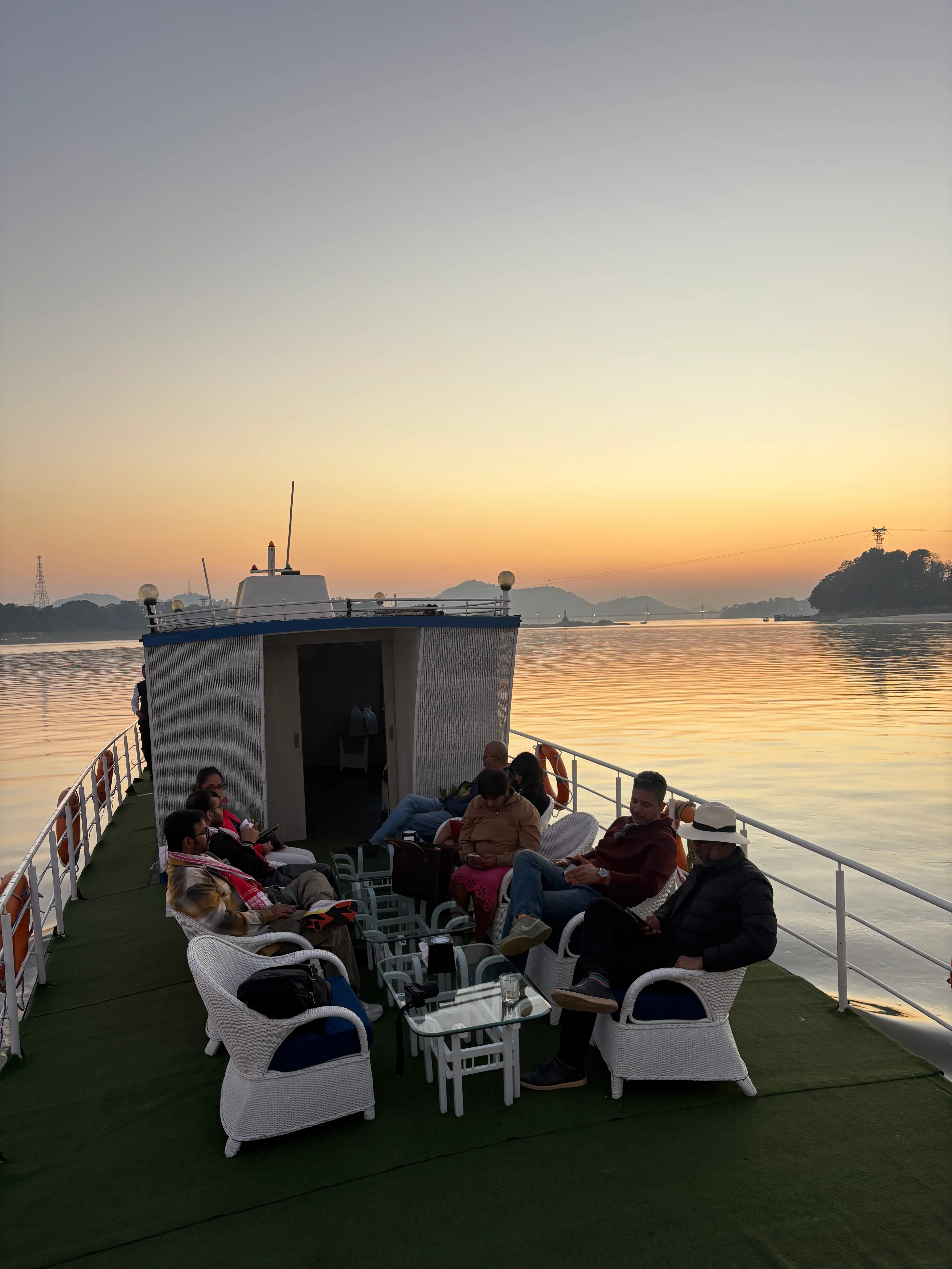 Guests on the bow deck of S B Agam at sunset